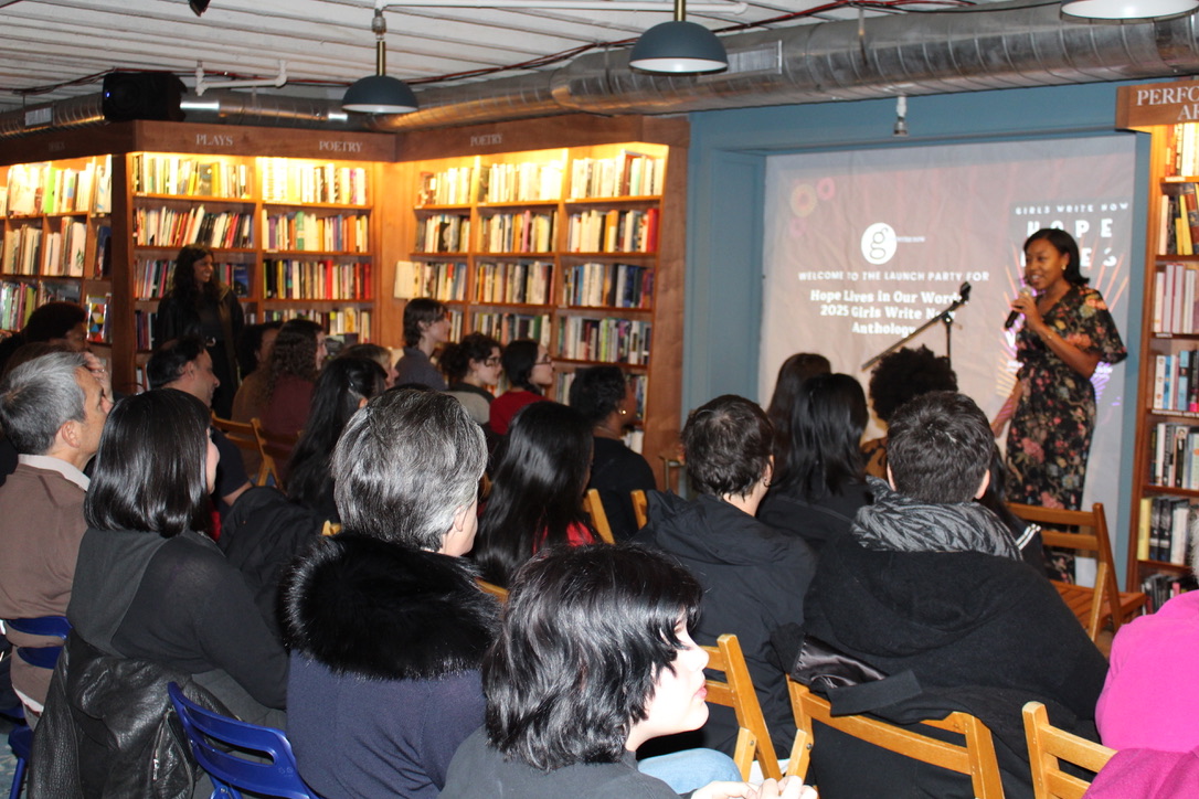 a group of people sit in chairs at McNally Jackson as Azia Armstead introduced the 2025 anthology launch party at the front